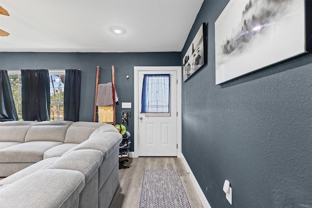 105 S Lavaca St, Whitney, TX 76692 - foyer entrance with light wood-style floors, baseboards, and a textured wall