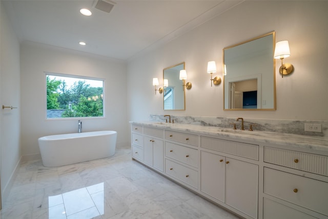 9621 Larchcrest Dr, Dallas, TX 75238 - bathroom with double vanity, a freestanding tub, marble finish flooring, recessed lighting, and baseboards