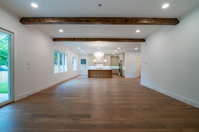 9621 Larchcrest Dr, Dallas, TX 75238 - unfurnished living room featuring beam ceiling, a chandelier, plenty of natural light, wood finished floors, and baseboards