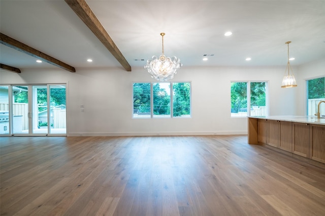 9621 Larchcrest Dr, Dallas, TX 75238 - unfurnished living room featuring a chandelier, healthy amount of natural light, beam ceiling, light wood-style flooring, and recessed lighting
