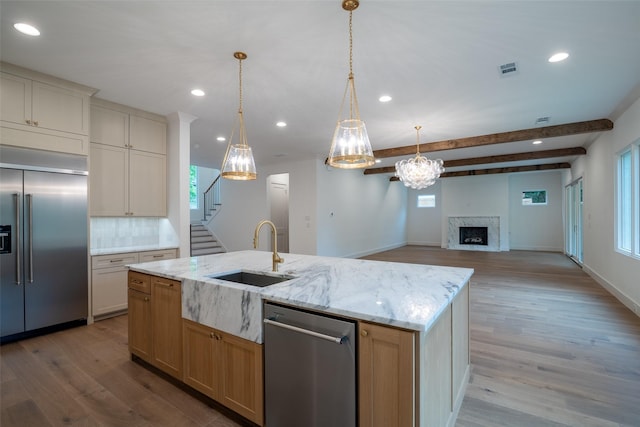 9621 Larchcrest Dr, Dallas, TX 75238 - kitchen with appliances with stainless steel finishes, a sink, wood finished floors, a fireplace, and recessed lighting
