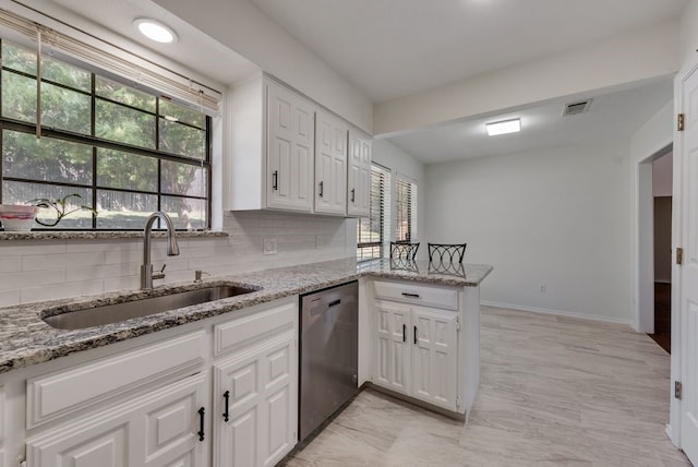7020 Live Oak Dr, North Richland Hills, TX 76182 - kitchen featuring stainless steel dishwasher, a sink, and white cabinetry