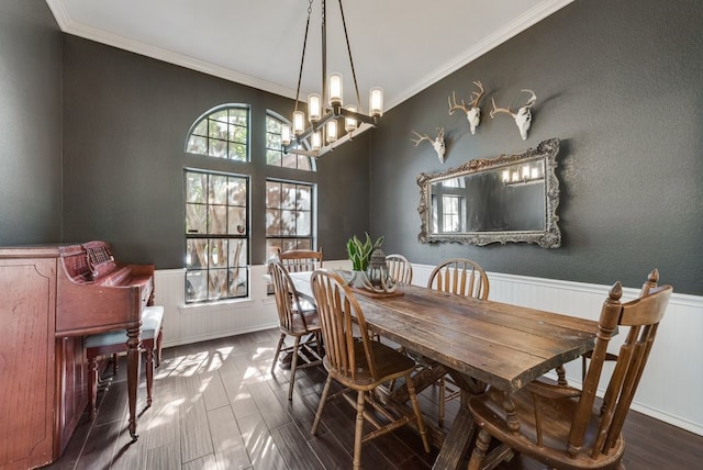 7020 Live Oak Dr, North Richland Hills, TX 76182 - dining space with a wainscoted wall, ornamental molding, a chandelier, and wood finished floors