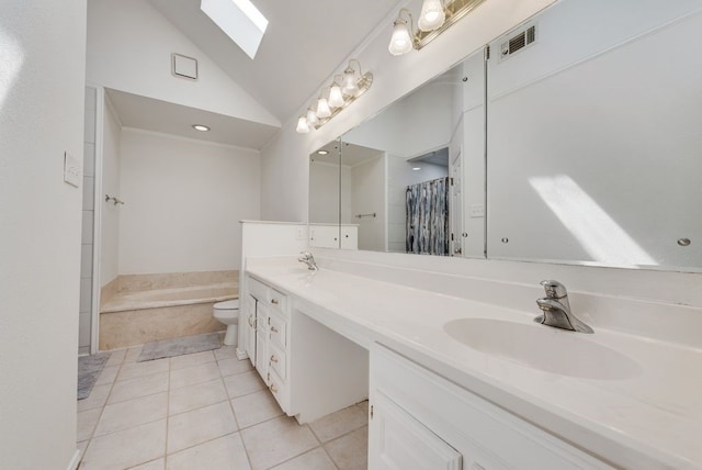 7020 Live Oak Dr, North Richland Hills, TX 76182 - full bathroom featuring tile patterned floors, double vanity, a garden tub, high vaulted ceiling, and toilet