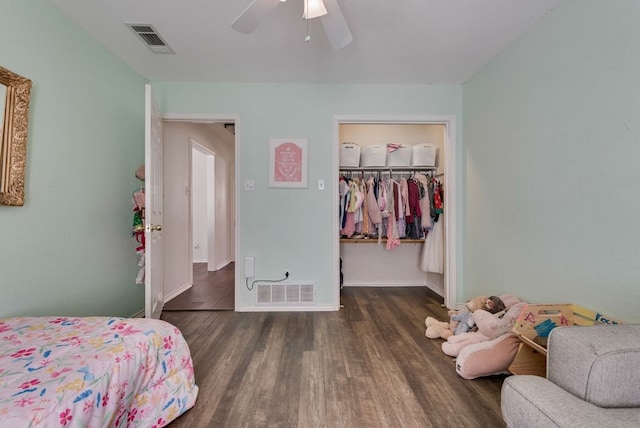 7020 Live Oak Dr, North Richland Hills, TX 76182 - bedroom with wood finished floors, a walk in closet, baseboards, a closet, and a ceiling fan