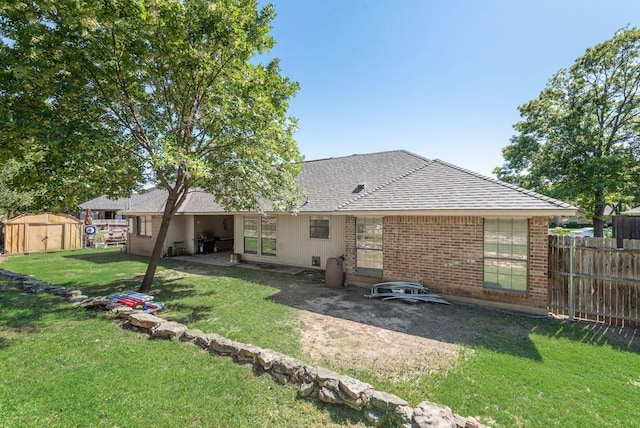 7020 Live Oak Dr, North Richland Hills, TX 76182 - back of house featuring a shingled roof, brick siding, and a patio area