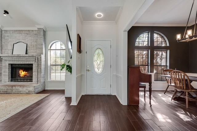 7020 Live Oak Dr, North Richland Hills, TX 76182 - foyer entrance with plenty of natural light, a chandelier, dark wood-style flooring, and crown molding