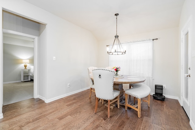 1519 Fairweather Way, Forney, TX 75126 - dining area featuring a chandelier, wood finished floors, baseboards, and vaulted ceiling