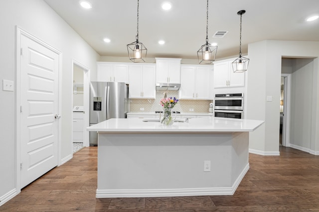 1519 Fairweather Way, Forney, TX 75126 - kitchen with stainless steel appliances, tasteful backsplash, a center island with sink, dark wood-type flooring, and recessed lighting