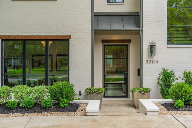3204 Westminster Ave, University Park, TX 75205 - doorway to property featuring brick siding and a standing seam roof
