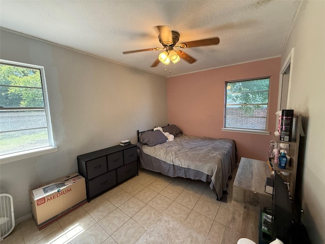 1403 Little St, Copperas Cove, TX 76522 - bedroom featuring light tile patterned floors, a textured ceiling, and a ceiling fan