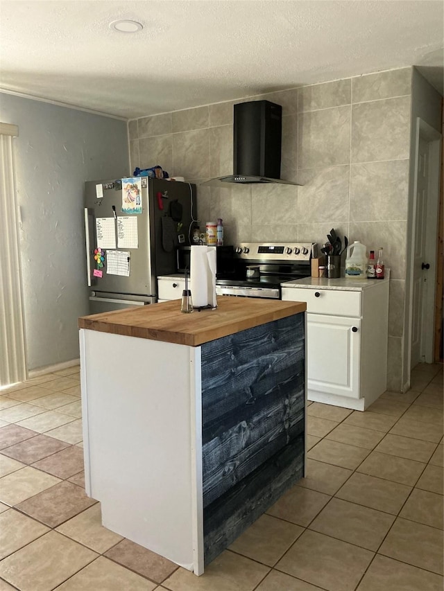 1403 Little St, Copperas Cove, TX 76522 - kitchen featuring wall chimney exhaust hood, appliances with stainless steel finishes, wooden counters, a textured ceiling, and white cabinetry