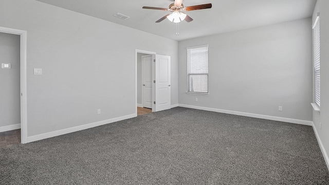 105 Leon Ave, Rhome, TX 76078 - unfurnished room featuring ceiling fan, dark carpet, and baseboards