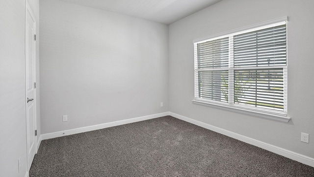 105 Leon Ave, Rhome, TX 76078 - empty room with dark colored carpet and baseboards