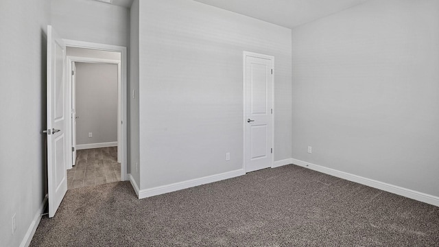 105 Leon Ave, Rhome, TX 76078 - unfurnished bedroom with dark carpet and baseboards