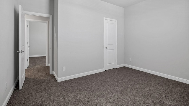 105 Leon Ave, Rhome, TX 76078 - unfurnished bedroom with dark carpet and baseboards