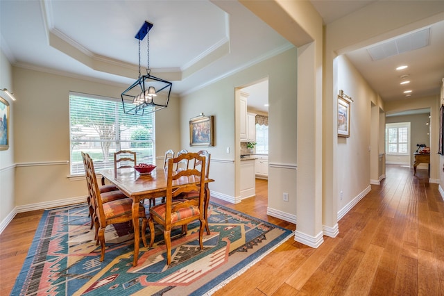 382 Burnswick Isles Way, Frisco, TX 75036 - dining area with light wood-style flooring, a tray ceiling, a chandelier, crown molding, and recessed lighting