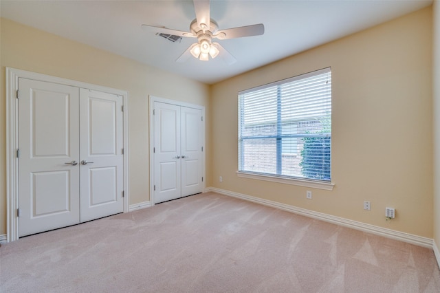 382 Burnswick Isles Way, Frisco, TX 75036 - unfurnished bedroom with multiple closets, carpet flooring, baseboards, and a ceiling fan