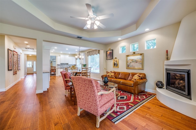 382 Burnswick Isles Way, Frisco, TX 75036 - living area featuring a fireplace, light wood-type flooring, recessed lighting, a raised ceiling, and ceiling fan