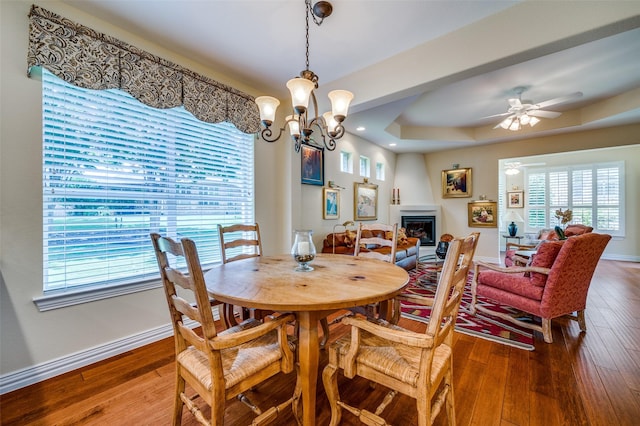 382 Burnswick Isles Way, Frisco, TX 75036 - dining space featuring plenty of natural light, a glass covered fireplace, hardwood / wood-style flooring, and baseboards