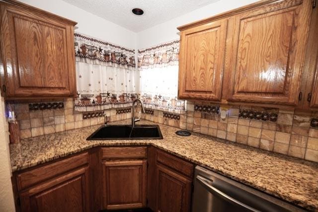 1111 Bayshore St, Allen, TX 75002 - kitchen featuring a sink, stainless steel dishwasher, decorative backsplash, and light stone countertops