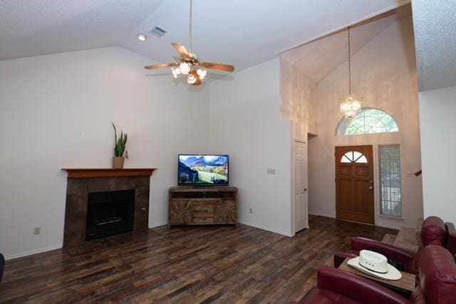 1111 Bayshore St, Allen, TX 75002 - living room with high vaulted ceiling, wood finished floors, a tile fireplace, a ceiling fan, and a chandelier