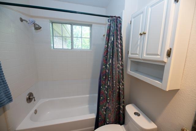 1111 Bayshore St, Allen, TX 75002 - bathroom featuring toilet and shower / tub combo with curtain