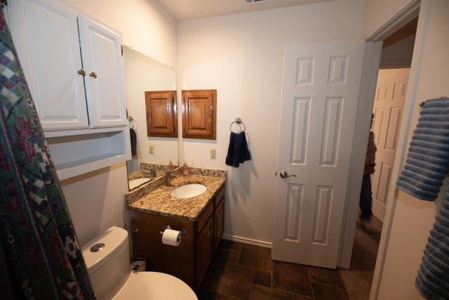 1111 Bayshore St, Allen, TX 75002 - full bathroom with vanity, toilet, and stone finish floors