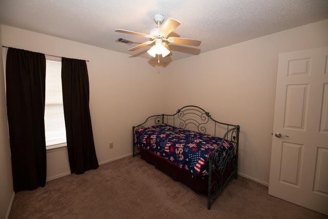 1111 Bayshore St, Allen, TX 75002 - carpeted bedroom with a ceiling fan, baseboards, and a textured ceiling
