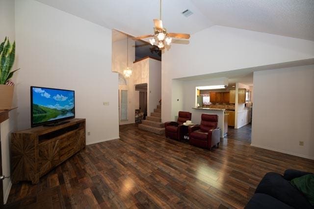 1111 Bayshore St, Allen, TX 75002 - living room with dark wood-type flooring, stairway, ceiling fan, high vaulted ceiling, and baseboards