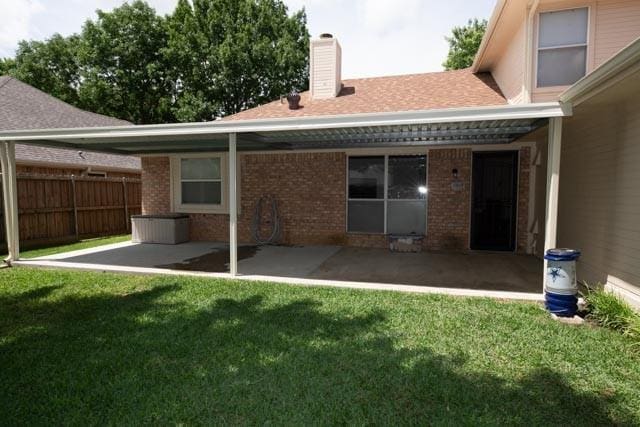 1111 Bayshore St, Allen, TX 75002 - back of property featuring a patio, brick siding, a chimney, and a shingled roof