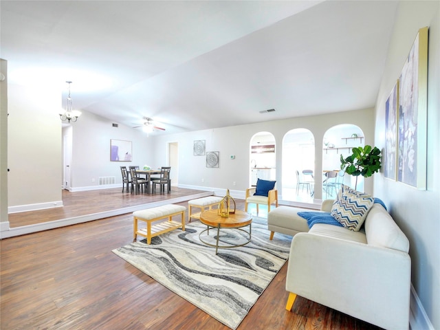 3609 Marwick Dr, Plano, TX 75075 - living room featuring wood finished floors, baseboards, a ceiling fan, vaulted ceiling, and a chandelier