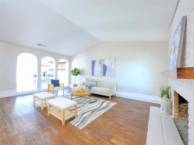 3609 Marwick Dr, Plano, TX 75075 - living room with baseboards, wood finished floors, vaulted ceiling, and a brick fireplace