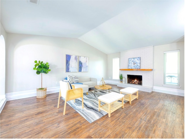 3609 Marwick Dr, Plano, TX 75075 - living area with wood finished floors, healthy amount of natural light, lofted ceiling, a brick fireplace, and baseboards