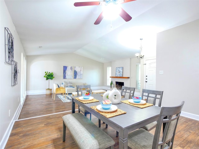 3609 Marwick Dr, Plano, TX 75075 - dining space featuring wood finished floors, a brick fireplace, ceiling fan, baseboards, and lofted ceiling