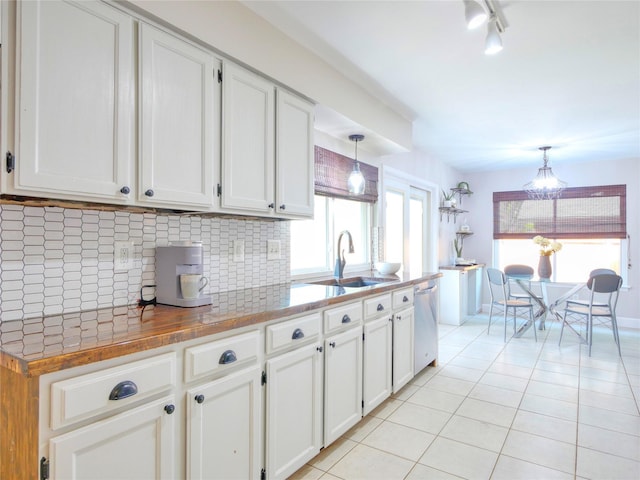 3609 Marwick Dr, Plano, TX 75075 - kitchen with a sink, dishwasher, light tile patterned floors, tasteful backsplash, and white cabinetry