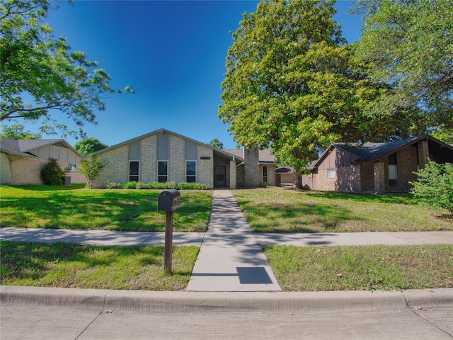 3609 Marwick Dr, Plano, TX 75075 - mid-century inspired home featuring a front lawn and brick siding