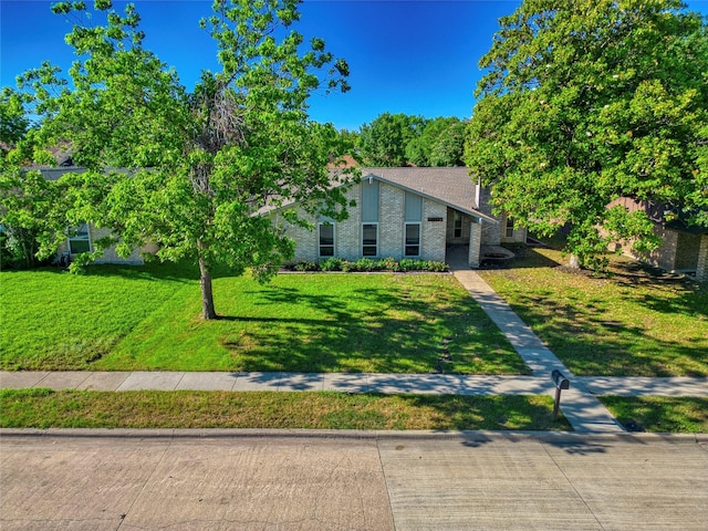 3609 Marwick Dr, Plano, TX 75075 - mid-century inspired home featuring a front yard and brick siding
