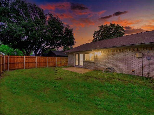 3609 Marwick Dr, Plano, TX 75075 - back of property at dusk featuring brick siding and a patio area