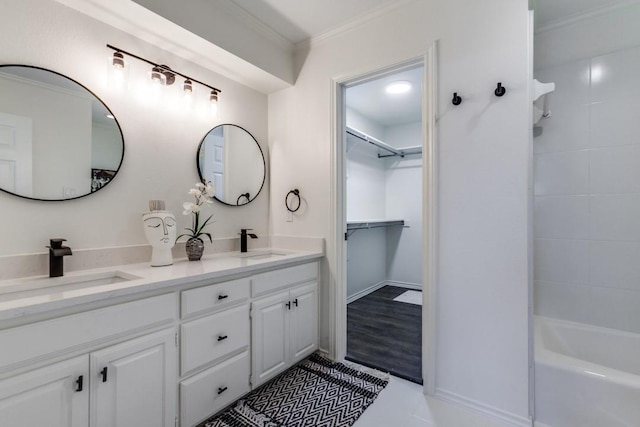 418 Vernet St, Richardson, TX 75080 - bathroom with double vanity, ornamental molding, shower / bathtub combination, a walk in closet, and tile patterned floors