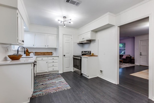 418 Vernet St, Richardson, TX 75080 - kitchen with stainless steel electric range oven, under cabinet range hood, dark wood finished floors, white cabinets, and crown molding