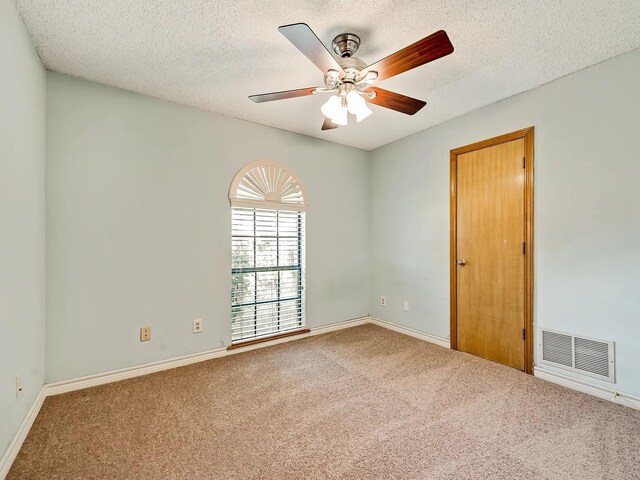 1101 Shawnee Trl, Carrollton, TX 75007 - carpeted empty room featuring a ceiling fan, a textured ceiling, and baseboards