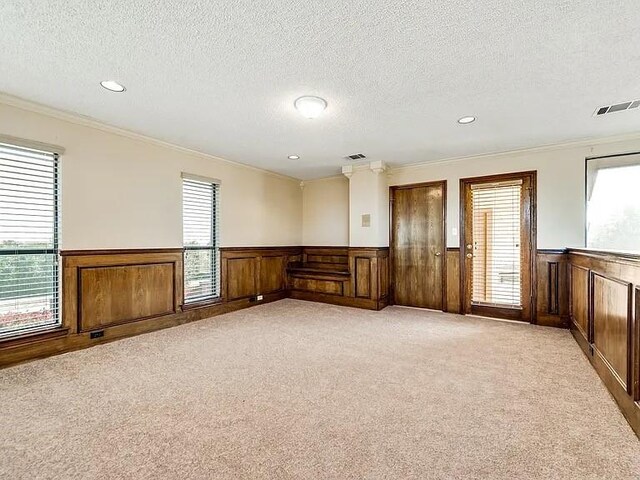 1101 Shawnee Trl, Carrollton, TX 75007 - empty room featuring wainscoting, a textured ceiling, light carpet, crown molding, and recessed lighting