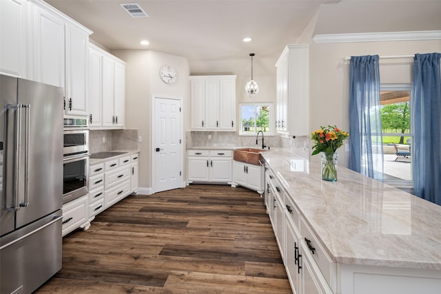 9390 Lakeridge Dr, Princeton, TX 75407 - kitchen with stainless steel appliances, a sink, a peninsula, white cabinetry, and tasteful backsplash
