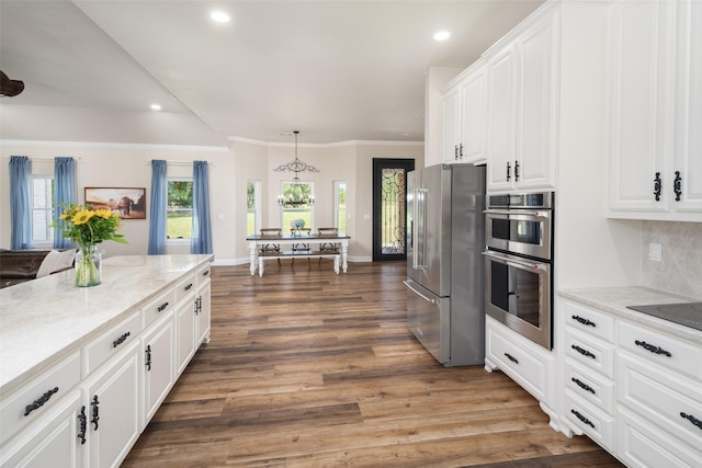 9390 Lakeridge Dr, Princeton, TX 75407 - kitchen featuring stainless steel appliances, recessed lighting, wood finished floors, white cabinets, and light stone countertops