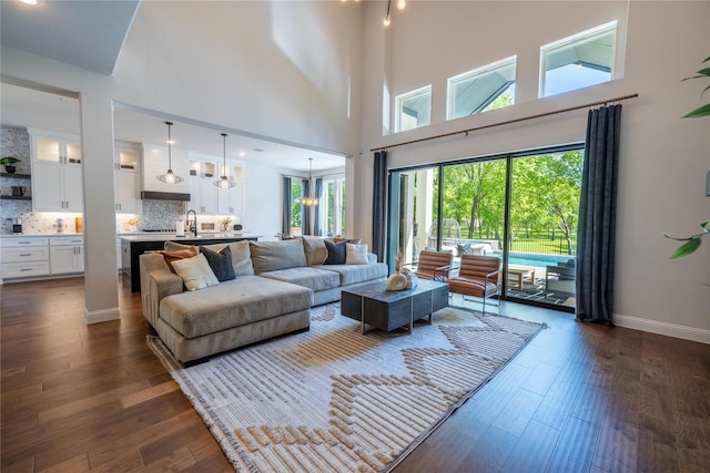 2402 Cornerstone Dr, Mansfield, TX 76063 - living area featuring dark wood-style floors, a high ceiling, and baseboards