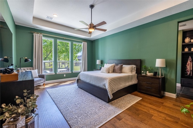 2402 Cornerstone Dr, Mansfield, TX 76063 - bedroom with a raised ceiling, wood finished floors, baseboards, and a ceiling fan
