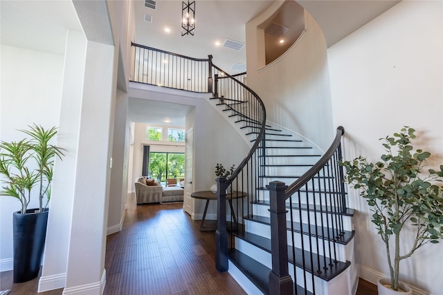 2402 Cornerstone Dr, Mansfield, TX 76063 - staircase with wood finished floors, a high ceiling, a chandelier, and baseboards