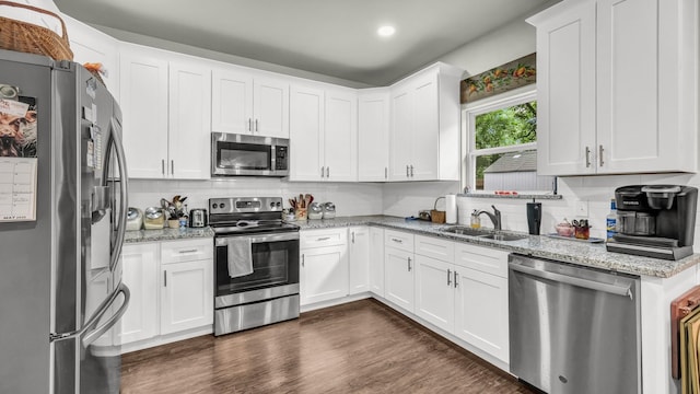 113 Myers Ave, Cleburne, TX 76033 - kitchen with stainless steel appliances, a sink, white cabinets, and light stone counters