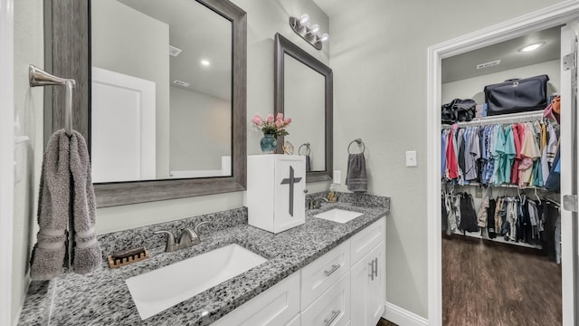 113 Myers Ave, Cleburne, TX 76033 - full bathroom with double vanity, wood finished floors, and a walk in closet